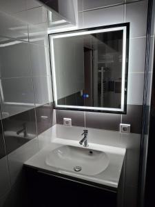 a bathroom with a sink and a mirror at La parenthèse secrète in Danvou +12 photos