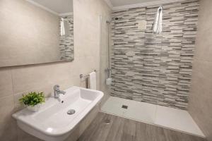 a white bathroom with a sink and a shower at Casa Rural Nito - Naturaleza y Descanso en Asturias in Villayón