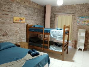 a room with two bunk beds and a bed at Origem Bahía in Salvador