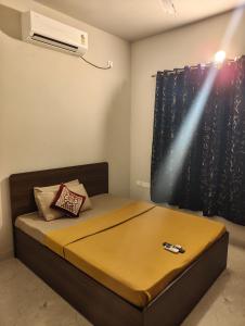 a bedroom with a bed with a air conditioner at Two Heart heaven in Covelong