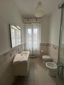a white bathroom with a sink and a toilet at Il Mare a due Passi in Pesaro +6 photos