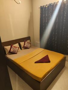 a bedroom with a bed with a red napkin on it at Two Heart heaven in Covelong