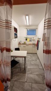 a room with a white table and a kitchen at Apartment Ferreira in Iseltwald