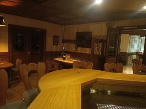 a dining room with a large wooden table and chairs at Hotel Büker in Erwitte