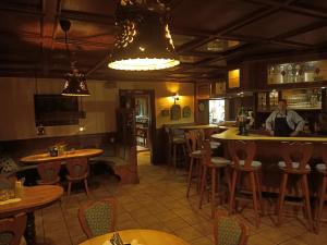 a man standing at a bar in a restaurant at Hotel Büker in Erwitte +4 photos