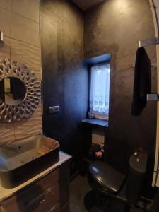 a bathroom with a sink and a mirror at Chambre bleue avec accès plage in Bourges +20 photos