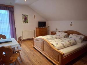 a bedroom with a wooden bed with a cross on the wall at Bauernhof Ablass in Göstling an der Ybbs