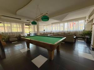 a billiard room with a pool table and chairs at Casa Obstei Caciulata in Caciulata