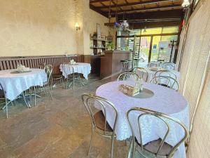 a dining room with tables and chairs in a restaurant at Casa Obstei Caciulata in Caciulata