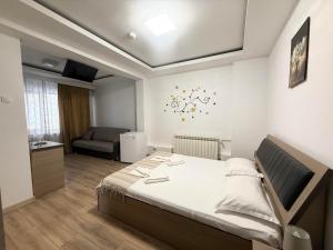 a bedroom with a bed and a living room at Casa Obstei Caciulata in Caciulata +37 photos