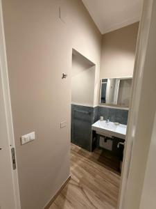 a bathroom with a sink and a mirror at Titti's Nest in Casteldaccia
