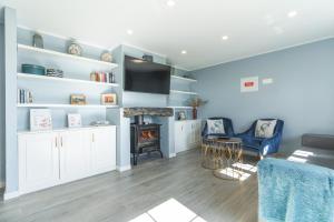 a living room with a couch and a fire place at Casa da Horta by Atlantic Holiday in Santa Cruz