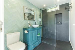 a bathroom with a blue cabinet and a sink at Casa da Horta by Atlantic Holiday in Santa Cruz +38 photos