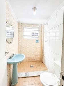 a bathroom with a sink and a toilet at Golfinho Hotel in São Vicente