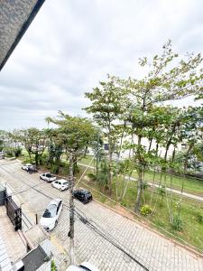 a view of a parking lot with cars parked at Golfinho Hotel in São Vicente +34 photos