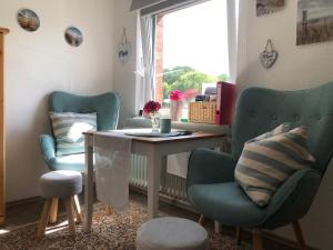 a room with two chairs and a table and a window at Gemütliches Inselnest mit großer Terrasse nahe Nordsee& Hafen in Tönning