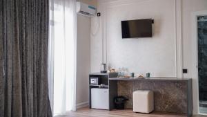 a living room with a television on the wall at Jagalau in Balqash