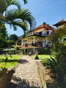 a large building with a walkway in front of it at Bukit Asri Lodge in Seraya