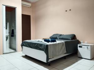 a bedroom with a bed and a glass shower at Origem Bahía in Salvador +29 photos