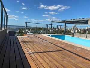 a rooftop deck with a view of the city at Alem Apartamento in La Porteña