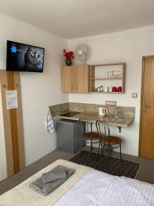 a small kitchen with a table and chairs in a room at Privat Alfa in Hrabušice