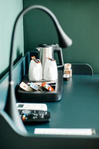a table with a tea pot and a remote control at City Tour Apartamenty in Poznań