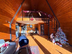 an overhead view of a living room with a christmas tree at Twin Cabins Azuga in Azuga +9 photos