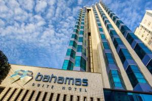 a building with a sign on the side of it at Duplex com Banheira no Centro de Campo Grande in Campo Grande