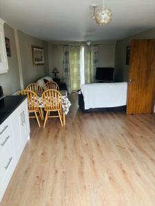 a bedroom with a bed and a table and chairs at Town Apartment in Ardara