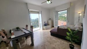 a living room with a bed and a table and a dining room at Vista dai pini in Varazze