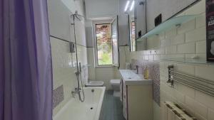 a bathroom with a tub and a toilet and a sink at Vista dai pini in Varazze