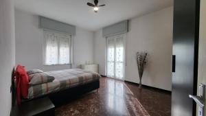 a bedroom with a bed and a ceiling fan at Vista dai pini in Varazze