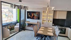 a kitchen with a dining table and a fireplace at The View -Balkan Tower безплатно паркомясто in Gabrovo