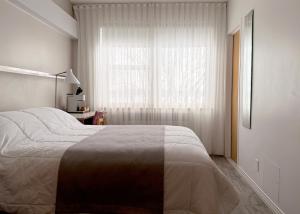 a bedroom with a large bed and a window at Manoir d'Youville in Châteauguay Heights