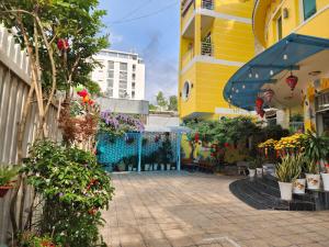 a courtyard of a building with flowers and plants at Ngoc Son Hotel in Bien Hoa +111 photos