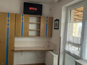 a kitchen with wooden cabinets and a window at Privat Alfa in Hrabušice +14 photos