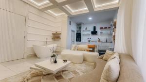 a living room with a couch and a table at French quarters apartments in Alaguntan