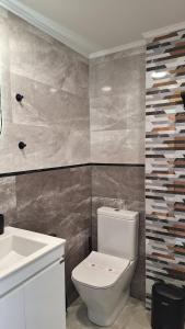 a bathroom with a white toilet and a sink at The View -Balkan Tower безплатно паркомясто in Gabrovo +20 photos