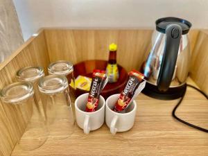 two cups with toothbrushes and glasses on a table at Tropical pool villa คอฟฟี่มีเขาสาขา2 in HHQ