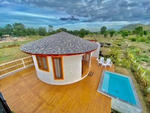 a small house with a deck and a swimming pool at Tropical pool villa คอฟฟี่มีเขาสาขา2 in HHQ