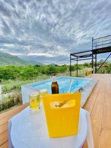 a bottle of wine on a table next to a pool at Tropical pool villa คอฟฟี่มีเขาสาขา2 in HHQ