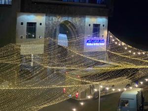 a building with christmas lights on the side of it at Midhal Al Ezz Ajyad Hotelفندق مدهال العز in Mecca +207 photos