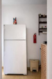 a white refrigerator in the corner of a kitchen at Puerto Plata Home in San Felipe de Puerto Plata
