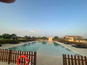 a swimming pool with a red ring in the middle at Complejo Rural Santa Emma in Herencia