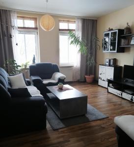 a living room with a couch and a coffee table at Ferienwohnung HARZgeNUSS in Wernigerode