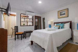 a bedroom with a large bed and a dining room at Puerto Plata Home in San Felipe de Puerto Plata