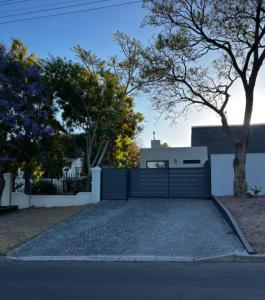 a house with a fence and a driveway at Alicante in Worcester