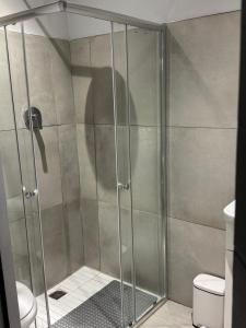 a shower with a glass door in a bathroom at Alicante in Worcester +6 photos