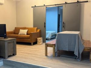 a living room with a couch and a table at Alicante in Worcester