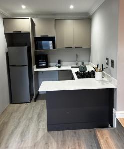 a kitchen with a white counter top and a refrigerator at Alicante in Worcester